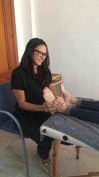 Rebecca using reflexology on a ladies feet Picture